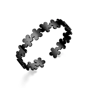 Detailed view of the continuous black floral pattern on this titanium steel open bangle
