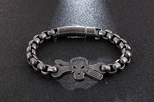 Macro view of industrial skull bracelet with wrench and screwdriver detail on steel links