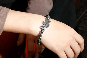 Macro view of vintage stainless steel skull bracelet featuring retro silver rabbit design