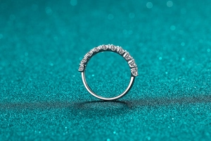 Macro shot of silver S925 sterling silver band ring with eleven sparkling round gemstones
