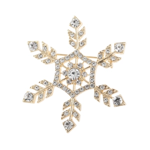 Classic golden snowflake brooch with sparkling crystals and pearl on white background