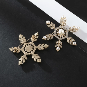 Front and back detail of gold snowflake brooches with pearls and rhinestones