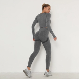 Seamless grey yoga set featuring high waist leggings and long sleeve cropped top