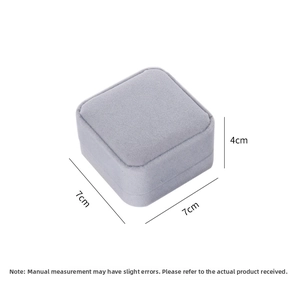 Macro detail of square blue-grey velvet jewelry box showing precise 7x7x4cm dimensions