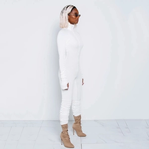 Detail showing white long sleeve ruched jumpsuit with high neck design and slim fit style