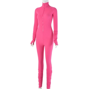 Detail of pink ribbed long sleeve jumpsuit with front zipper and textured fabric
