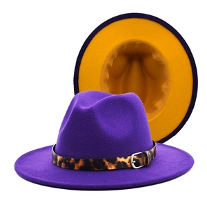 Detailed view of purple wool fedora with leopard print belt and yellow contrast interior