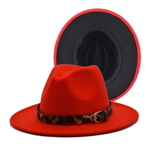 Detail of red fedora hat with leopard print band and contrasting black underbrim