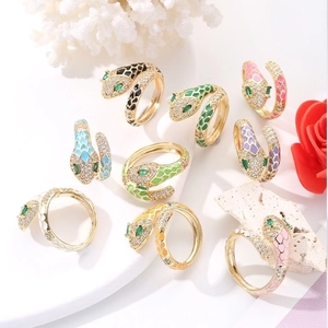Detailed view of nine colorful enamel snake rings with zircon stones and gold plating