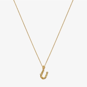 Detailed macro view of vintage gold S925 silver U-letter pendant with irregular texture