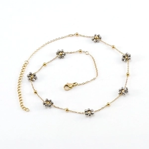 Minimalist gold chain necklace featuring crystal flower charms and faceted gray beads