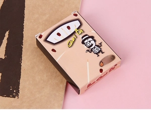 Detail view of 20pcs matchstick pen gift box set on pink and kraft paper background