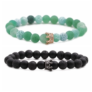 Detail of 8mm volcanic lava and green agate beads bracelet set with crown charms