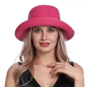 Close-up of the textured weave and bow detail on a rose red straw sun hat