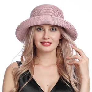 Detail of pink straw sun hat showing exquisite woven texture and elegant decorative brim