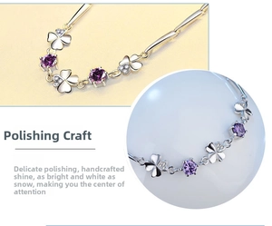 Detail of s925 silver four-leaf clover bracelet with purple zircon and polished finish
