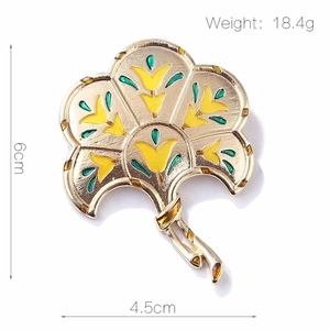 Detail showing dimensions of vintage gold fan brooch with yellow and green enamel work