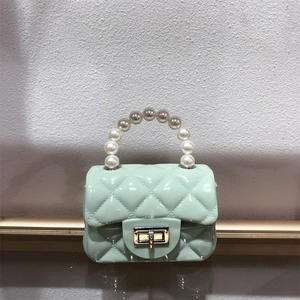 Mini light green PVC jelly bag with quilted pattern, pearl handle, and gold metal lock