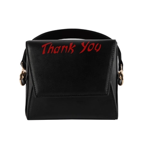 Close-up of black PU crossbody bag with red Thank You print and golden chain strap