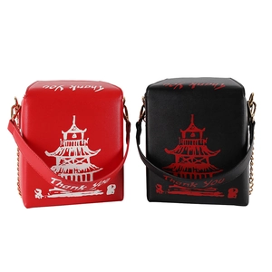 Detail view of red and black PU crossbody bags featuring tower print and chain straps