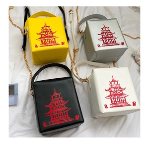 Top view of creative takeout box bags in four colors with red pagoda print and gold chains