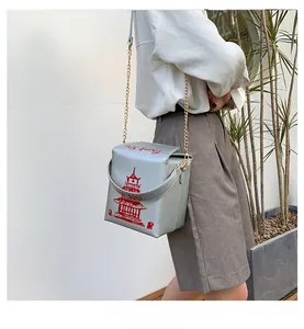 Detail of silver takeout box crossbody bag featuring red Thank You print and chain strap