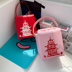 Detail view of red and pink square PU purses with Chinese pagoda print and chain strap