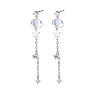 Detail of silver long tassel earrings with dreamlike planet, star and moonstone bead