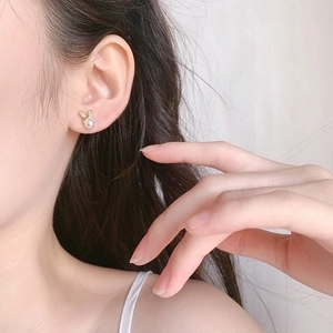 Exquisite gold bunny stud earrings with mermaid pearl detail for women on ear