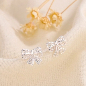 Elegant hollow butterfly bow stud earrings in silver finish with heart cutout details
