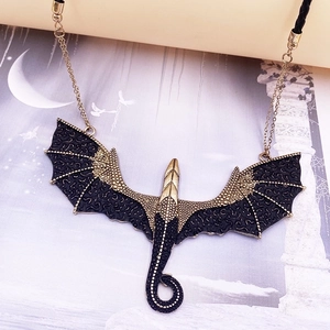 Gothic dragon pendant necklace in antique gold and black on mystical art background