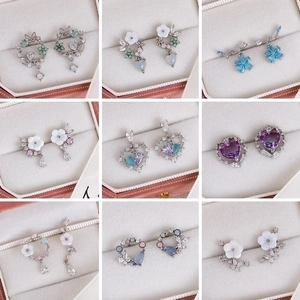Pink floral cubic zirconia stud earrings set in a 9-piece collection display
