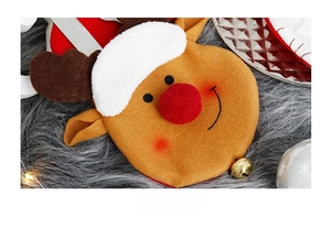 Detail of Christmas reindeer felt cutlery holder with red nose and gold bell accessory