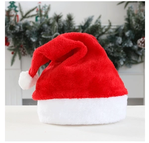 Detailed view of the soft plush texture and white pom-pom on a classic red Christmas hat