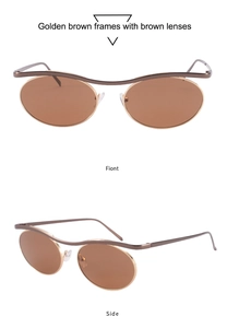 Macro view of golden brown metal oval sunglasses with wavy bridge and slim temples