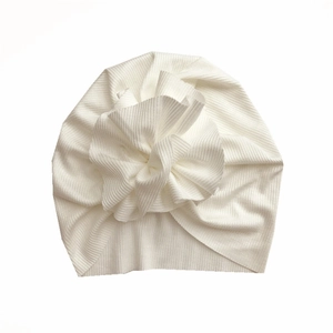 Detailed macro view of white ribbed knit fabric texture on the baby turban hat