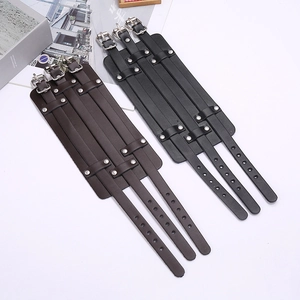Detail of adjustable black and brown layered leather bracelets with metal studs and buckles
