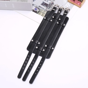 Detail of black multi-layer punk leather wristband with three silver metal buckles