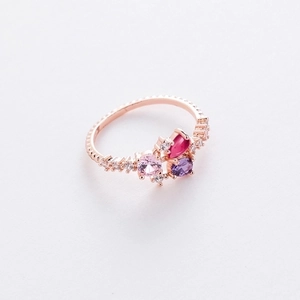 Macro view of rose gold floral ring with colorful gems and tiny crystal zircon stones