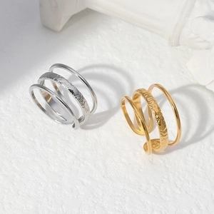 Macro detail of adjustable gold and silver titanium steel rings with hammered texture
