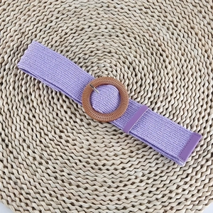 Detailed macro shot of a purple elastic woven belt with a round wood-grain buckle