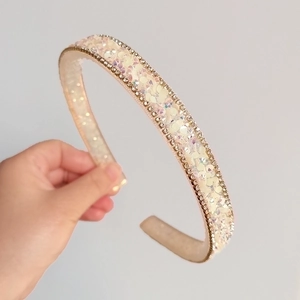 Close-up of pink sequin headband featuring sparkling rhinestone edges and wide band