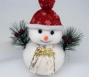 Detail of plush snowman Christmas ornament with Merry Christmas tag and snowflake scarf