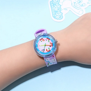 Close-up of children's purple unicorn strap watch worn on wrist with colorful numerals