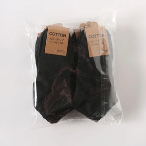 Detail view of cotton-wool blend ankle socks in dark grey packaged for retail display