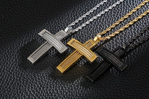 Detailed view of silver, gold and black hip-hop cross necklaces with steel wire inlay