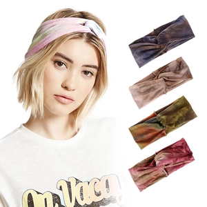 Detail of bohemian tie-dye knot headbands showing various colors and elastic fabric texture