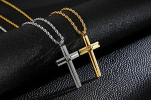 Close-up of gold and silver double-layered cross pendants on twisted rope chains