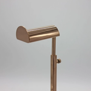 Detail of rose gold adjustable T-shaped handbag display stand with sleek metal finish