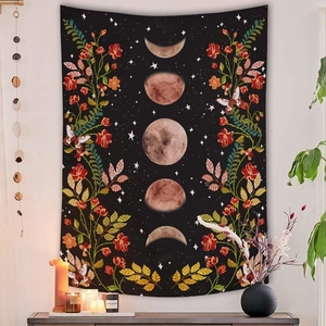 Macro detail of moon phases and floral print on bohemian black wall tapestry